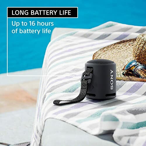 Portable speaker with long battery life on a beach towel.