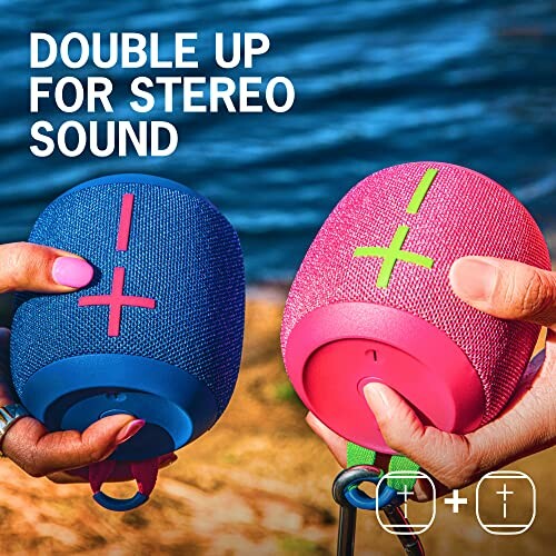 Two portable Bluetooth speakers in blue and pink for stereo sound.