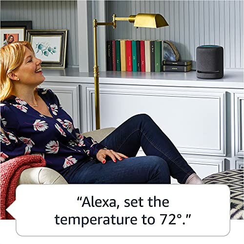 Woman using a smart speaker to set temperature.